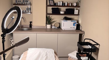 Warm, inviting treatment room at SOMA Skin Clinic, Kidderminster, England, GB, with sleek shelves and elegant decor.