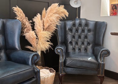 Luxurious seating at SOMA Skin Clinic, Kidderminster, England, GB with elegant armchairs and pampas decor.