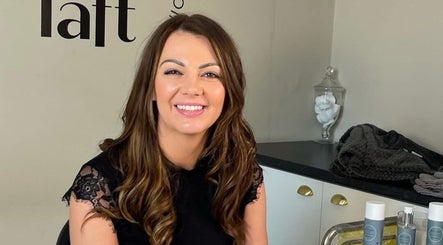 Smiling client at SOMA Skin Clinic in Kidderminster, England, surrounded by skincare products.