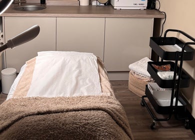 Cozy treatment room at SOMA Skin Clinic in Kidderminster, England, GB with treatment bed and equipment.
