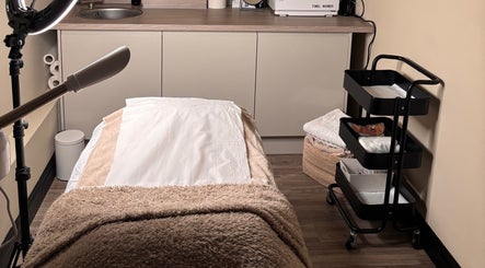 Cozy treatment room at SOMA Skin Clinic in Kidderminster, England, GB with treatment bed and equipment.