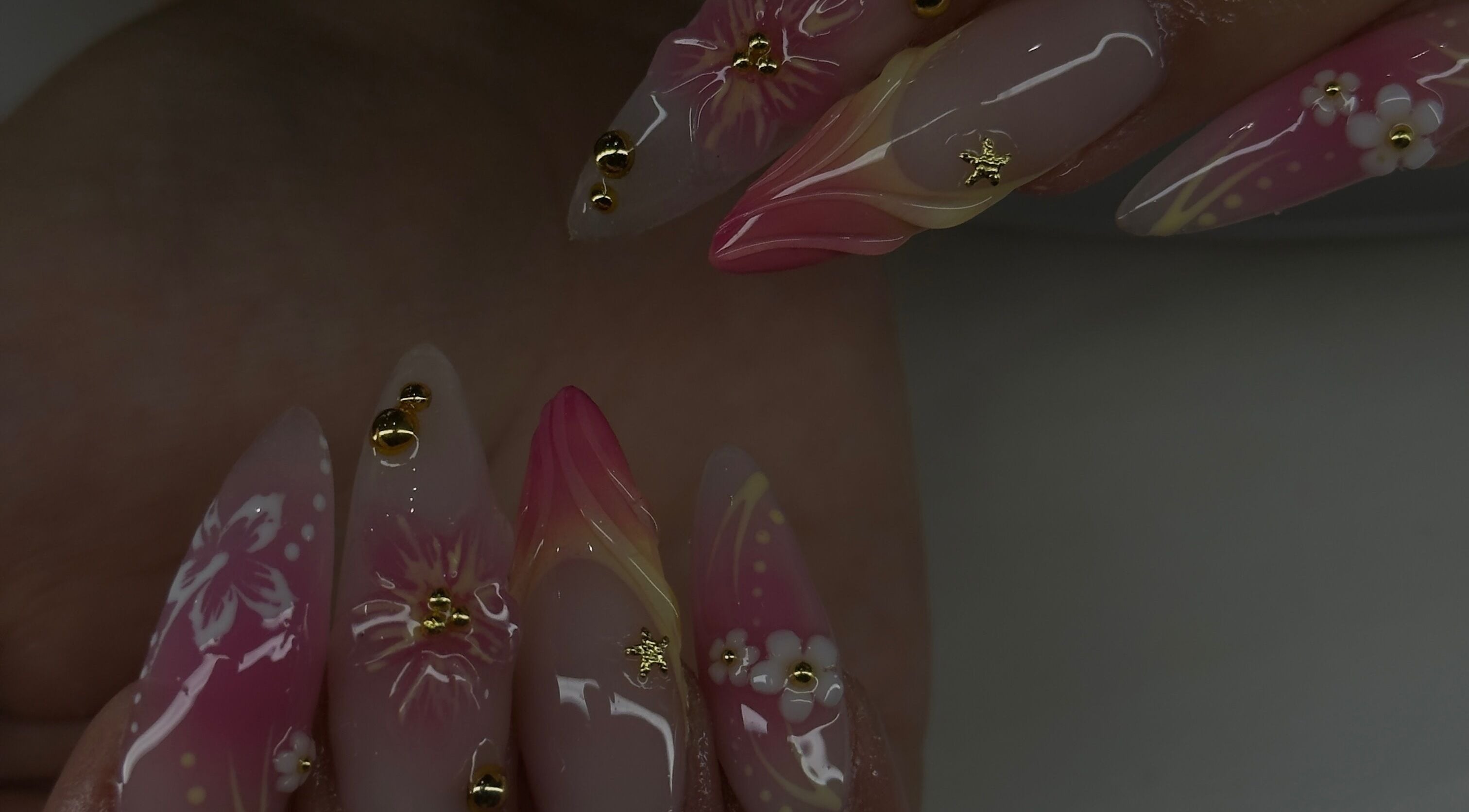 Intricate floral nail art at MadeByMaddie on Christchurch rd, England, GB. Elegant pink design with gold accents.