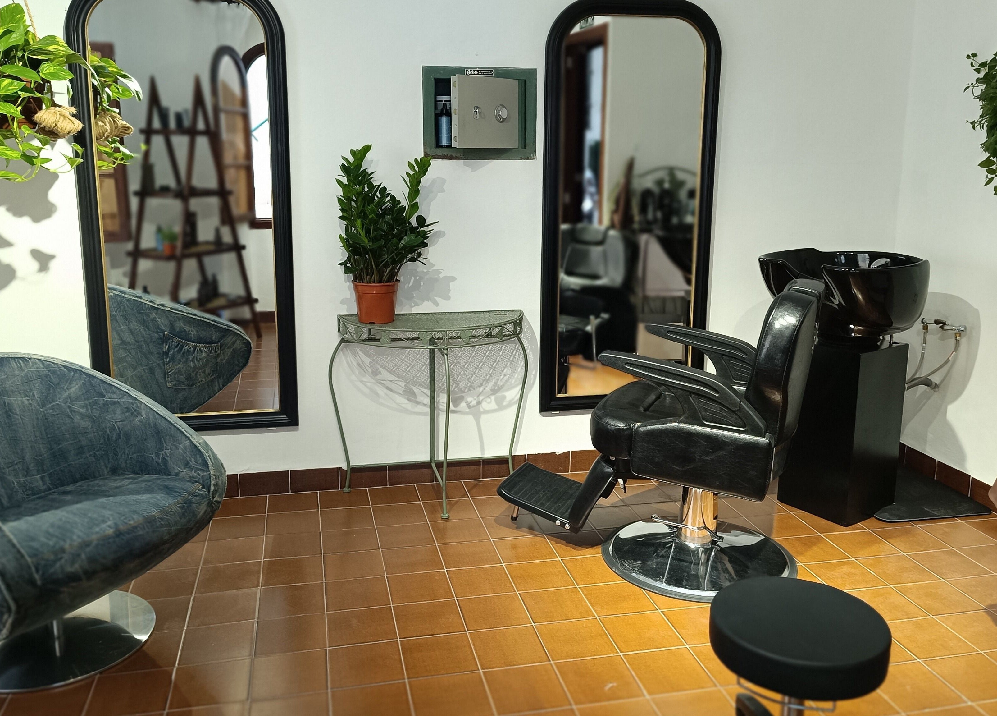 Modern barber chair and mirrors at Barberia Santanyi Man Escape in Santanyí, Illes Balears, ES.