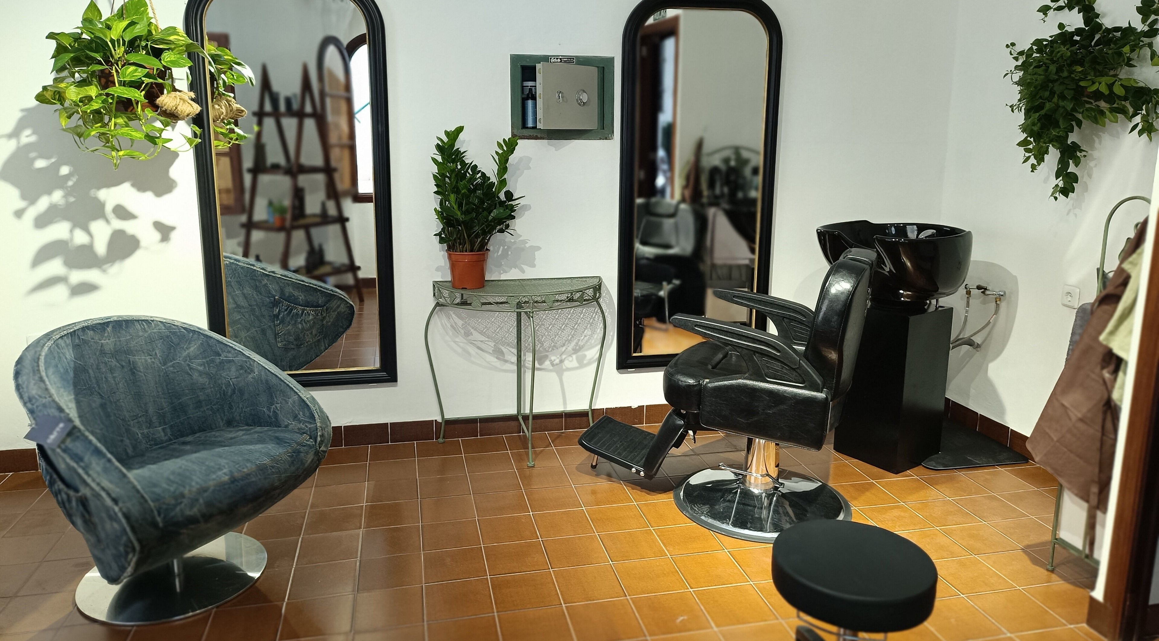 Modern barber chair and mirrors at Barberia Santanyi Man Escape in Santanyí, Illes Balears, ES.