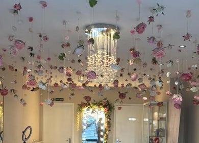 HMAKE Stockport, England, GB venue with hanging roses and elegant chandelier for a luxurious atmosphere.