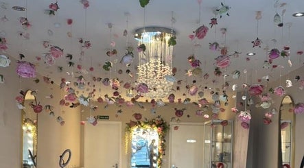 HMAKE Stockport, England, GB venue with hanging roses and elegant chandelier for a luxurious atmosphere.