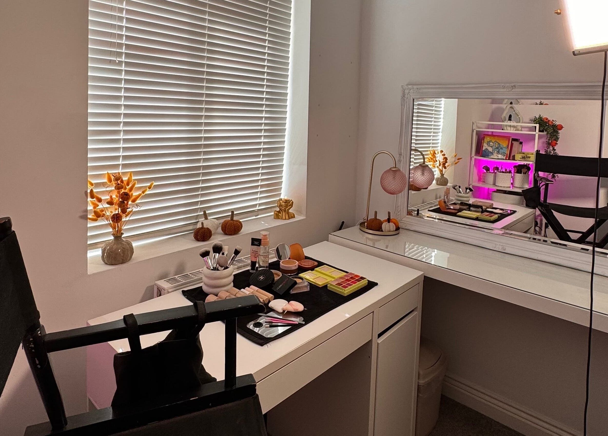 Cozy makeup room at Hmake, Stockport, England, GB with a mirror, cosmetics, and elegant decor.