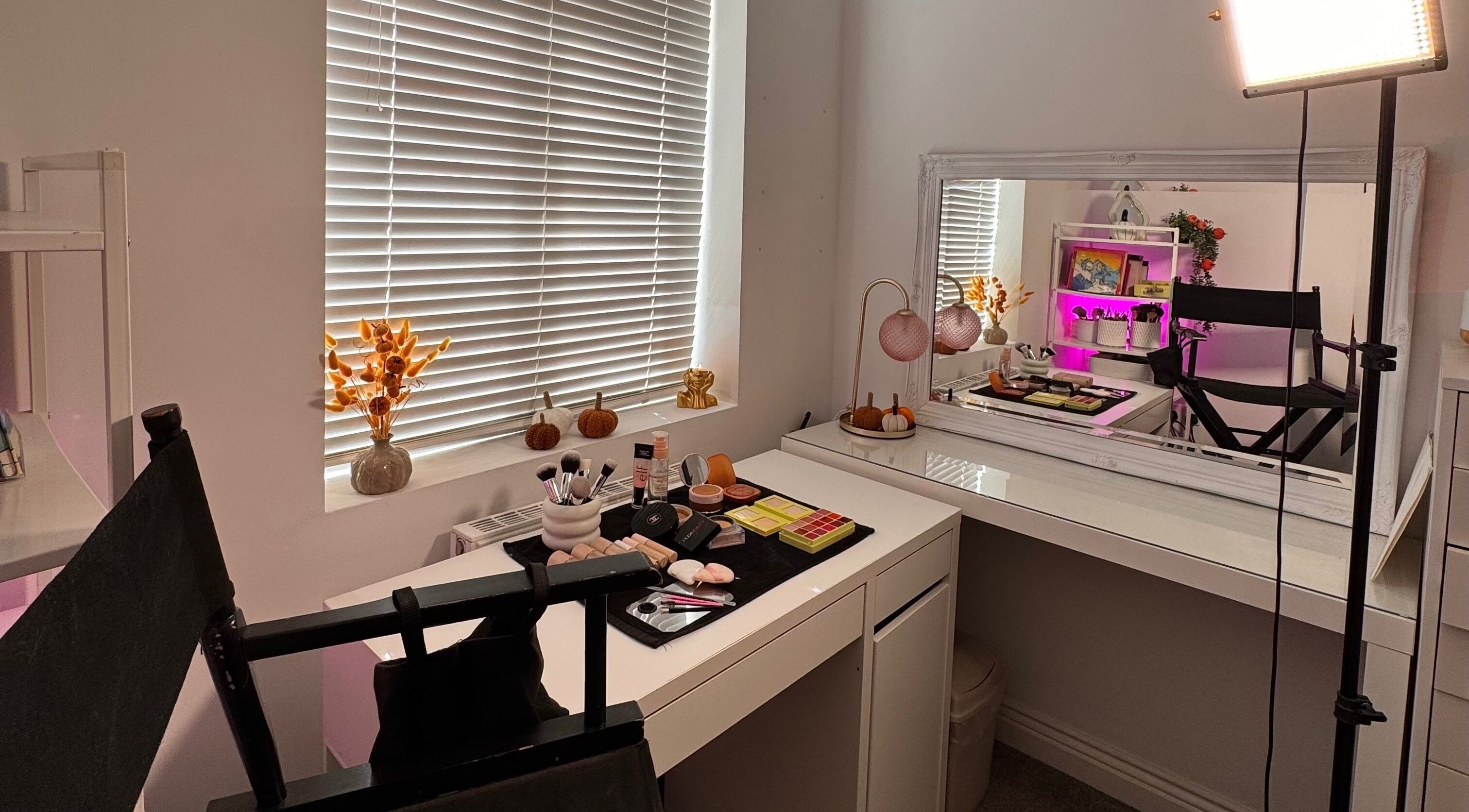 Cozy makeup room at Hmake, Stockport, England, GB with a mirror, cosmetics, and elegant decor.