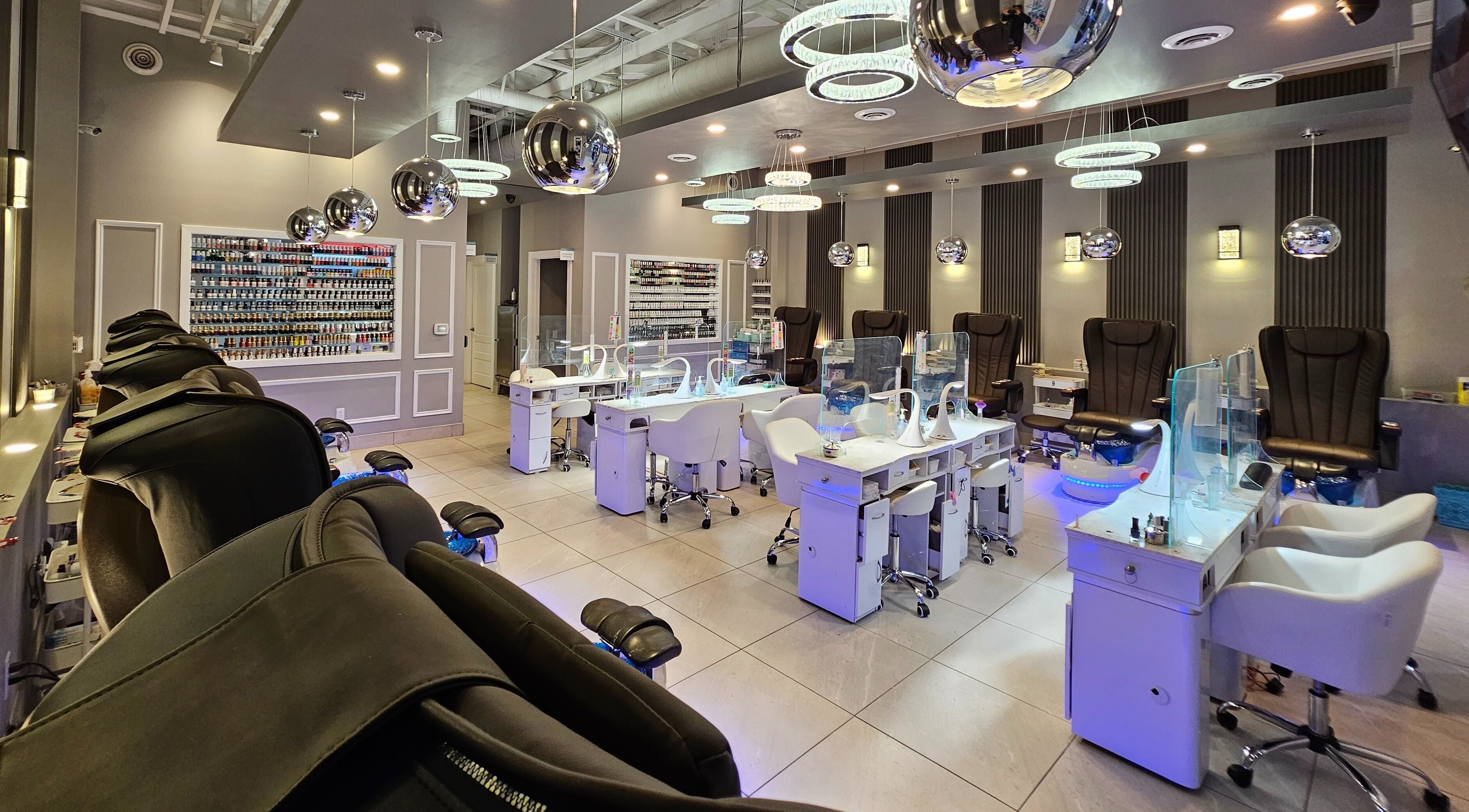 Modern interior of Huron Nail Salon in Kitchener, Ontario, CA with sleek manicure stations and stylish decor.