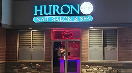 Front view of Huron Nail Salon in Kitchener, Ontario, CA with bright signage and open sign.