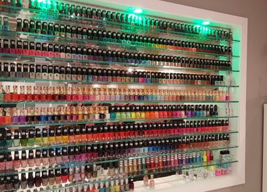 Colorful nail polish display at Huron Nail Salon in Kitchener, Ontario, CA. Extensive variety of shades available.