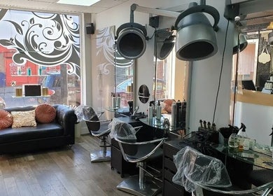 Elegant interior of The Salon in Wigan, GB, featuring modern styling chairs and decorative touches.