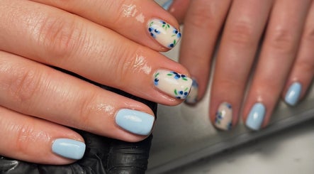 Elegant floral nails at Nails by Molly, Falkirk, Scotland, GB. Pastel blue and white polish with delicate flowers.