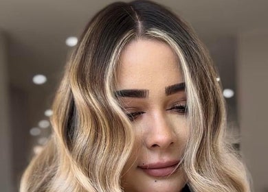 Styled wavy hair with blonde highlights at Ebony Vallender Hair and Extensions, Portsmouth, England, GB.