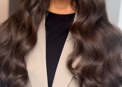 Long, wavy brown hair styled beautifully at Ebony Vallender Hair and Extensions, Portsmouth, England, GB.