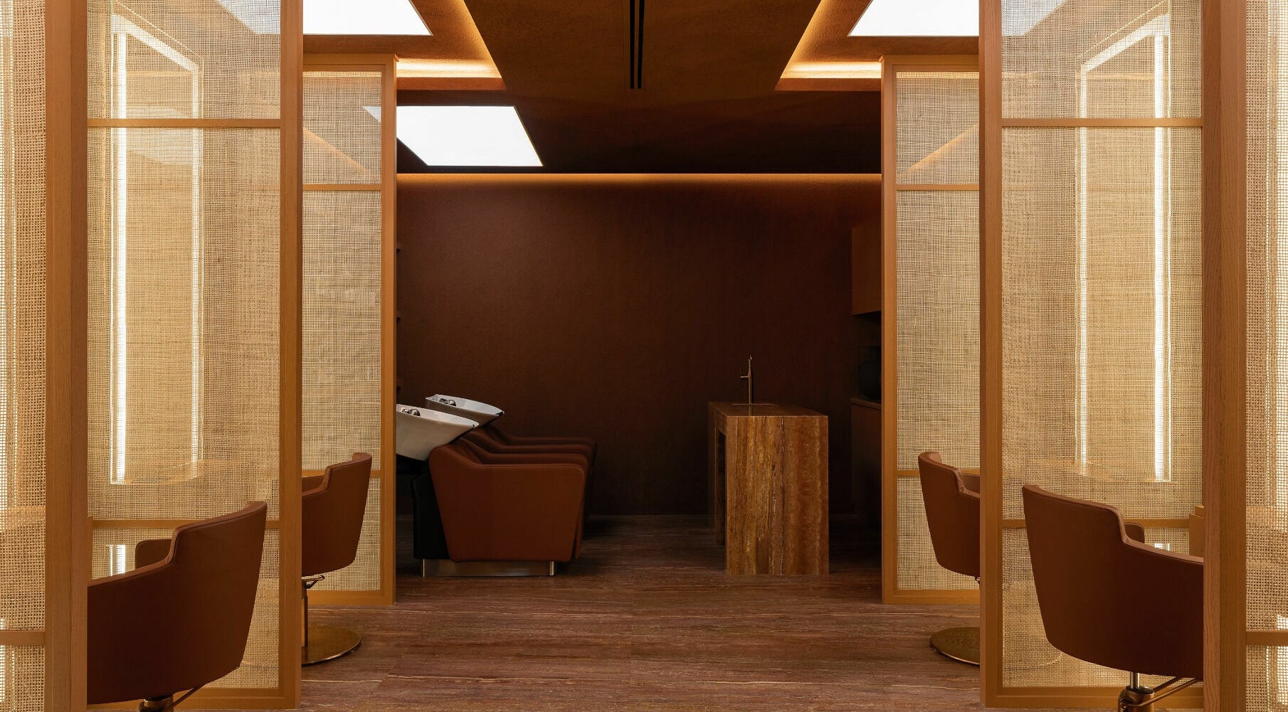 Elegant interior of Maison Nefertari Salon in Dubai, Dubai, AE showcasing modern chairs and warm lighting.