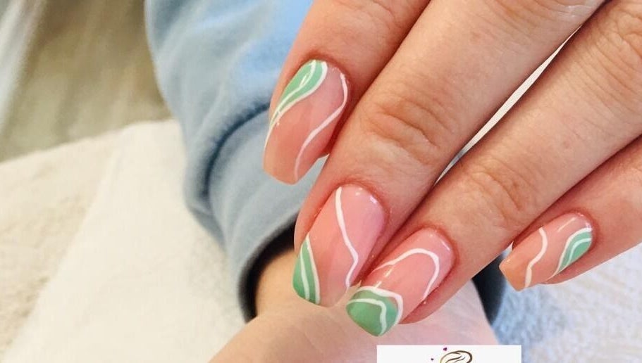 Beautiful nail art design at Gold'en Beauty Studio, Sandton, Gauteng, ZA. Pink nails with green and white accents.