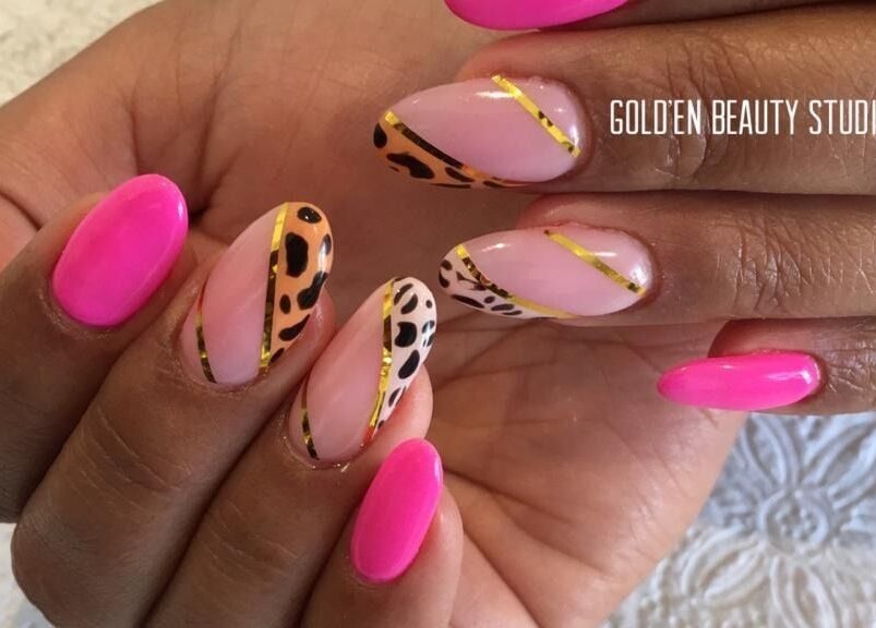 Elegant nail art featuring bright pink and leopard designs at Gold'en Beauty Studio, Sandton, Gauteng, ZA.