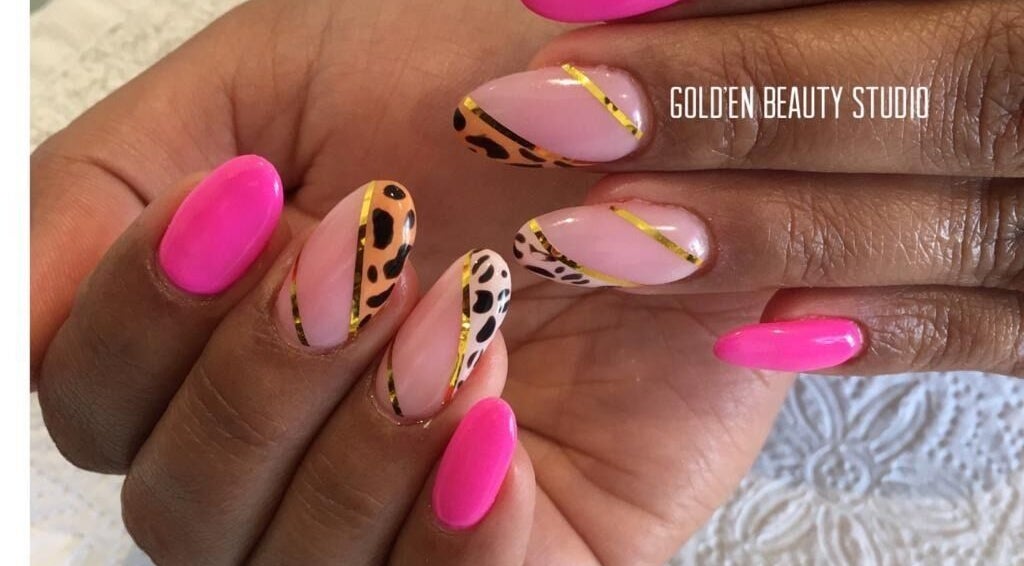 Elegant nail art featuring bright pink and leopard designs at Gold'en Beauty Studio, Sandton, Gauteng, ZA.