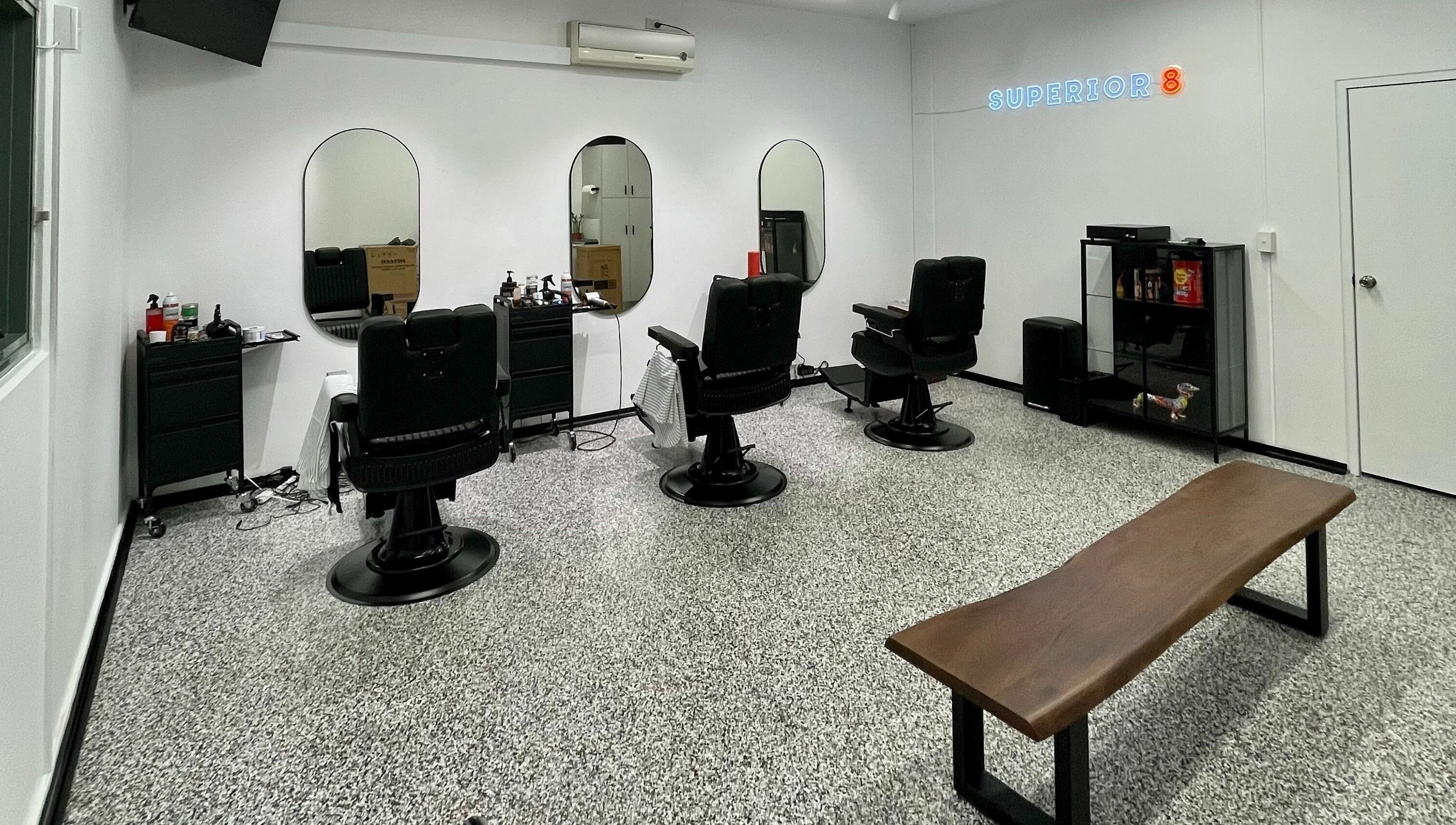 Modern barbershop chairs and mirrors at Superior 8 in Smeaton Grange, New South Wales, AU.