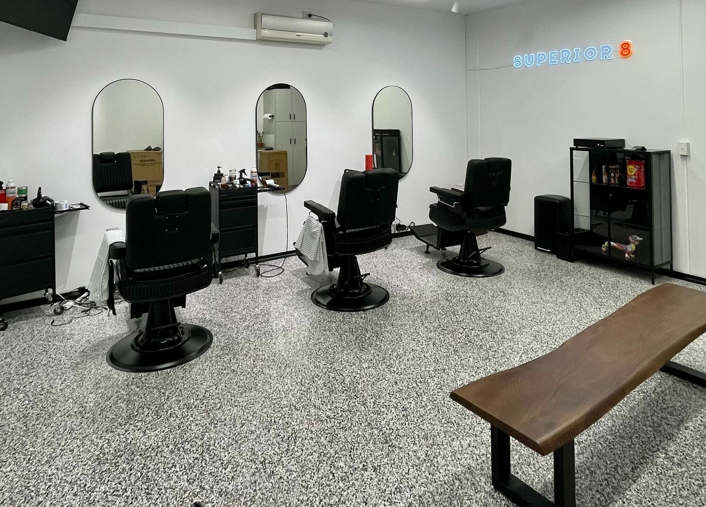 Modern barbershop chairs and mirrors at Superior 8 in Smeaton Grange, New South Wales, AU.