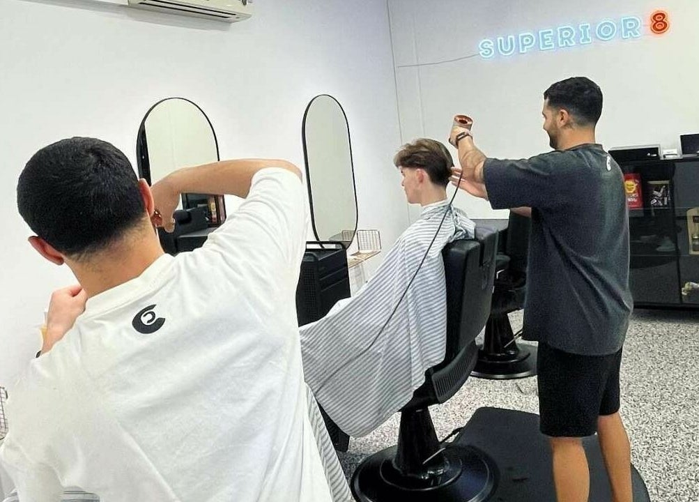 Stylist giving a modern haircut at Superior 8, Smeaton Grange, New South Wales, AU.