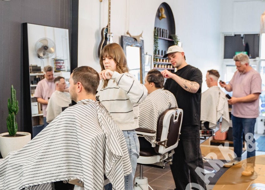 Professionals cutting hair at Dark and Stormy Barber Collective, Bendigo, Victoria, AU.