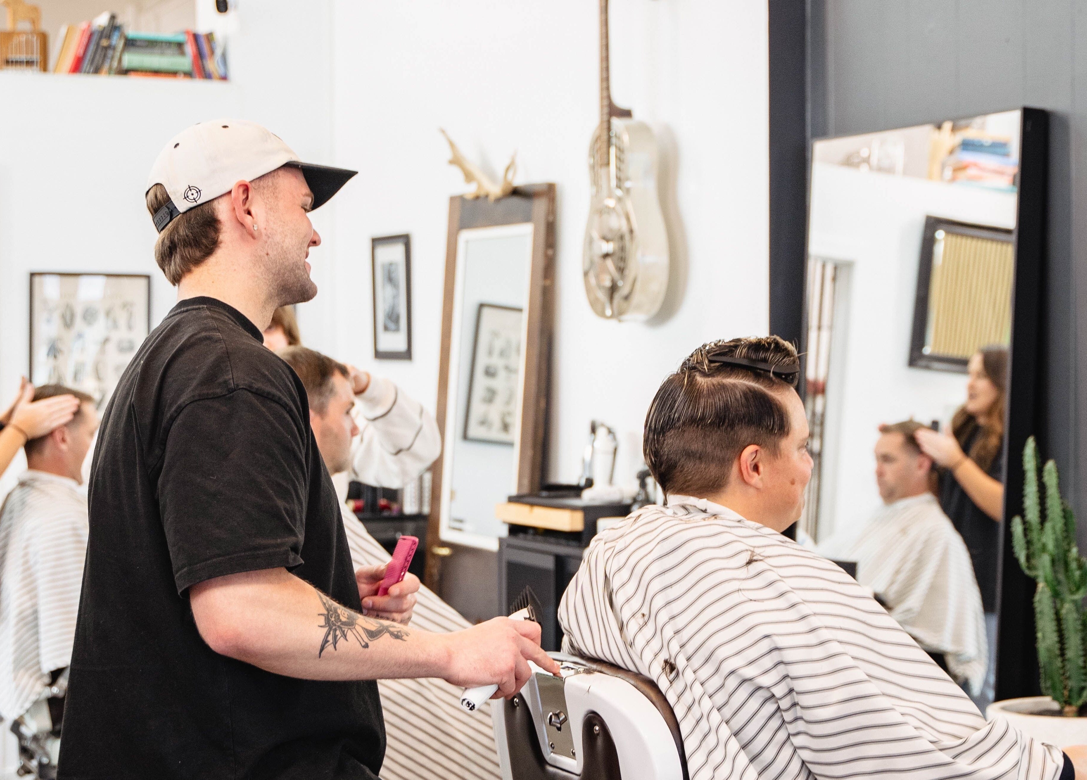 Barbers styling clients at Dark and Stormy Barber Collective in Bendigo, Victoria, AU.