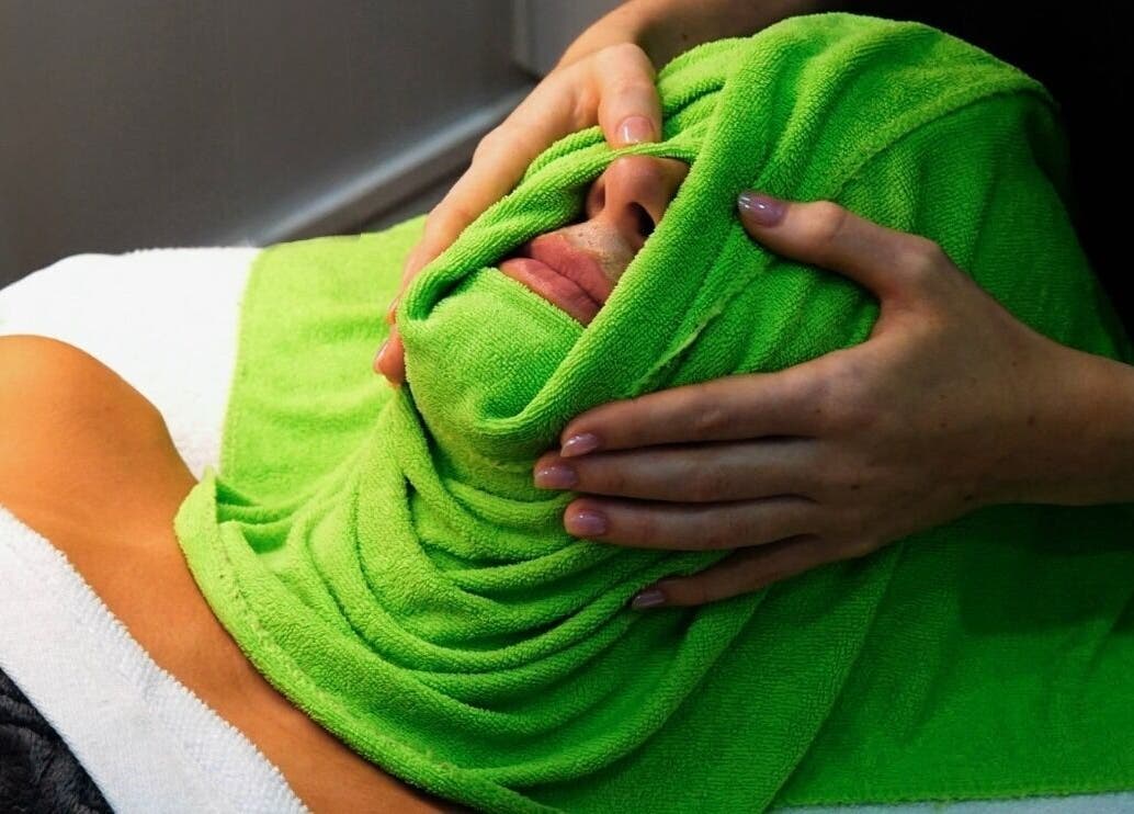 Relaxing facial treatment at Flawless Beauty Newport, Queensland, AU using a soothing green towel wrap.