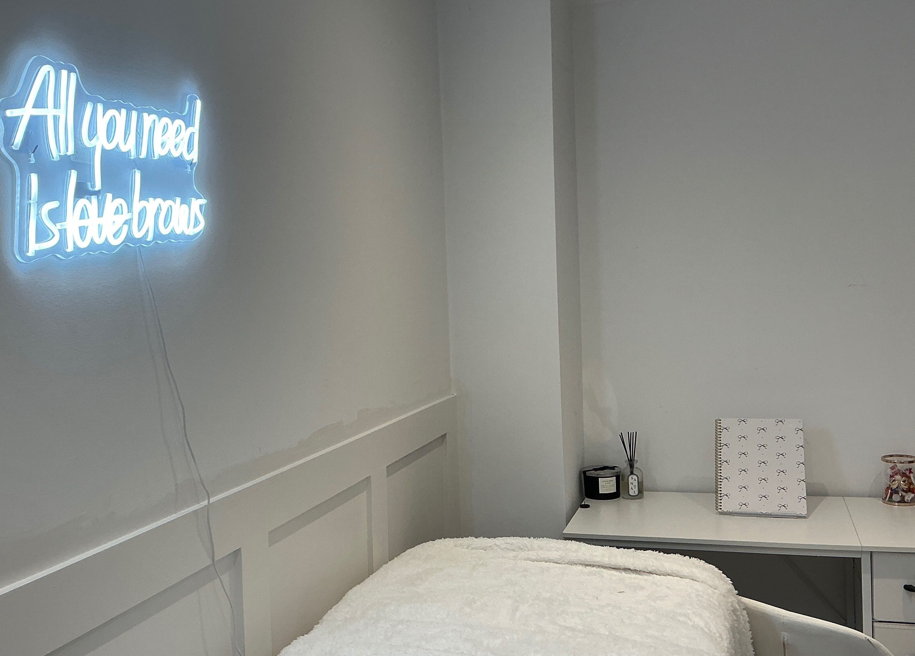 Elegant treatment room with neon sign at Brows by Lauren, Lincoln, England, GB.