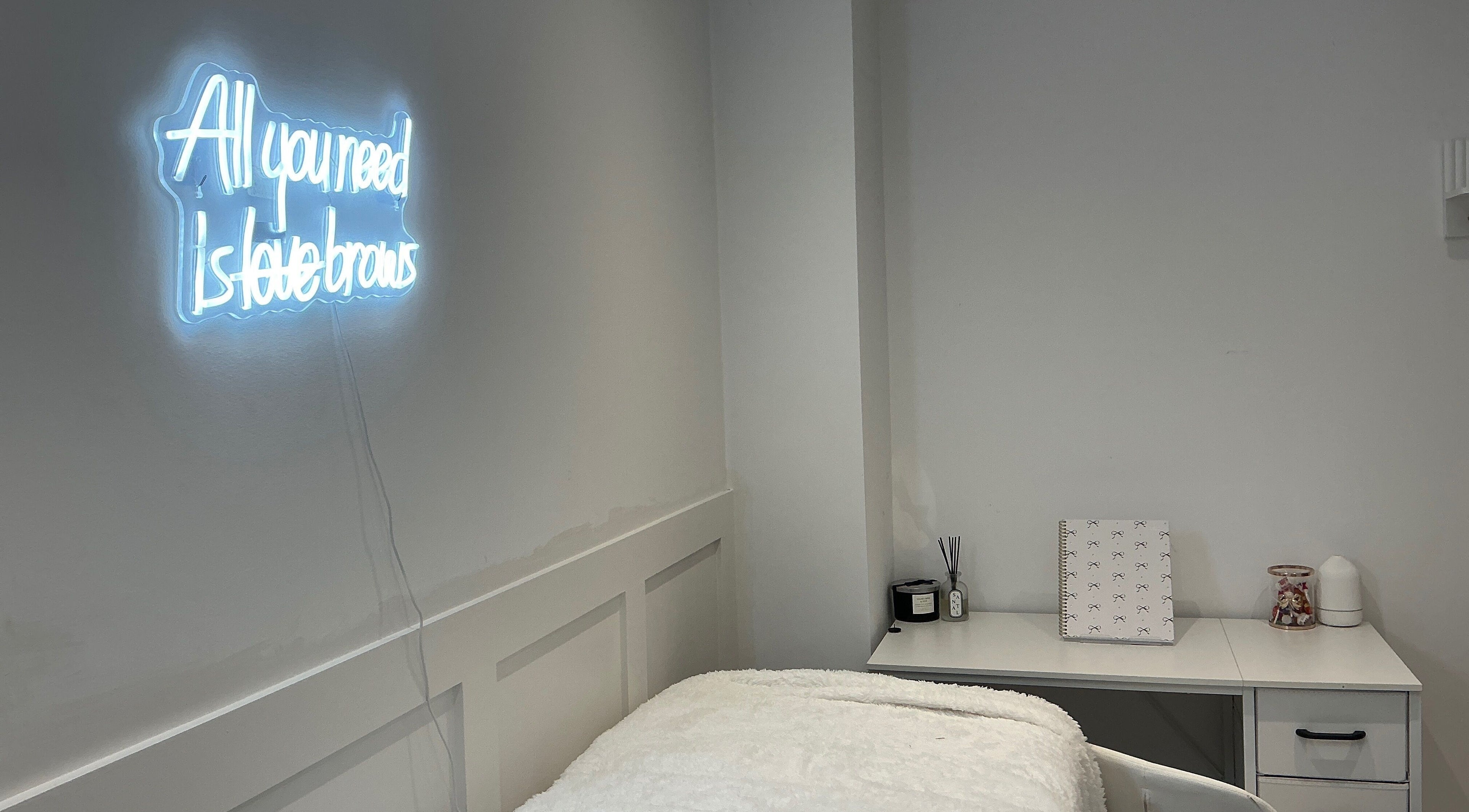 Elegant treatment room with neon sign at Brows by Lauren, Lincoln, England, GB.