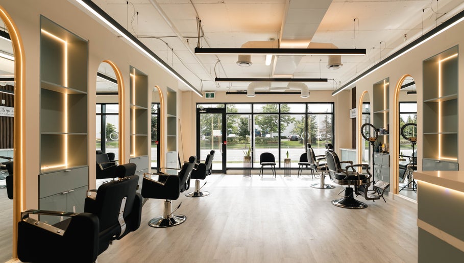Chic interior of KO CUTZ SALON & SPA, Mississauga, Ontario, CA with stylish chairs and modern lighting.