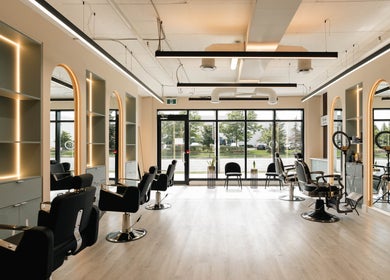 Chic interior of KO CUTZ SALON & SPA, Mississauga, Ontario, CA with stylish chairs and modern lighting.