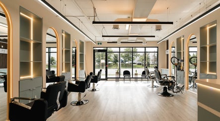 Chic interior of KO CUTZ SALON & SPA, Mississauga, Ontario, CA with stylish chairs and modern lighting.