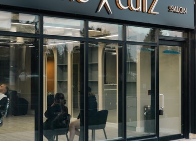 Front view of KO CUTZ SALON & SPA in Mississauga, Ontario, CA showing the stylish interior through large glass windows.