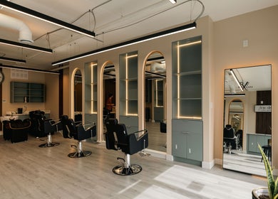 Interior view of KO CUTZ SALON & SPA in Mississauga, Ontario, CA with modern styling chairs and mirrors.