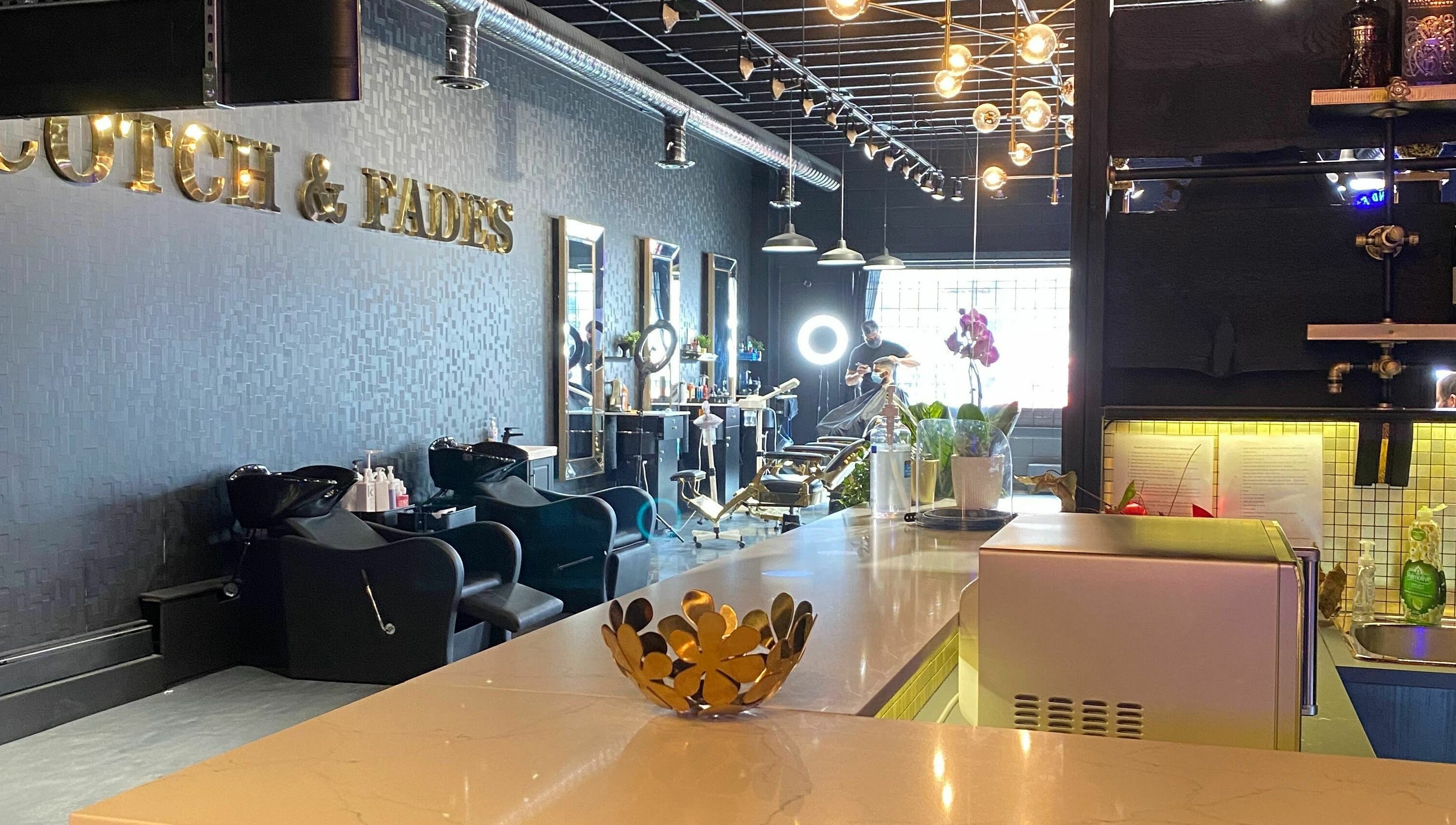 Sophisticated interior of Scotch and Fades salon in Vancouver, British Columbia, CA, featuring modern styling chairs.