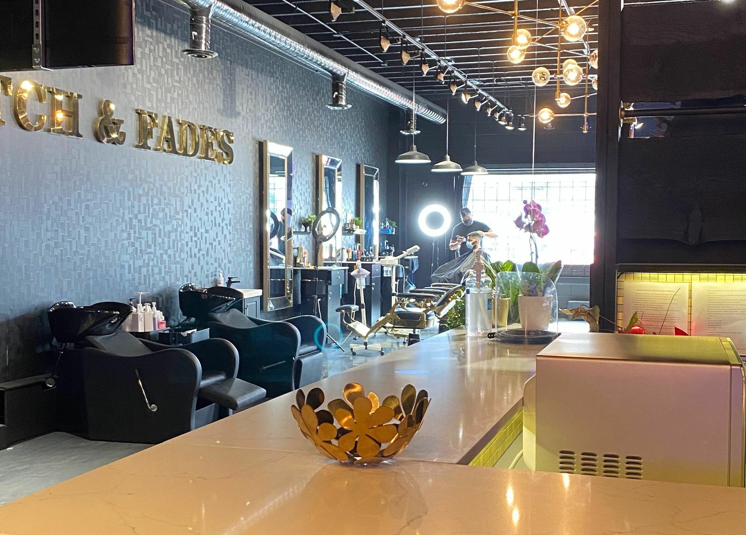 Sophisticated interior of Scotch and Fades salon in Vancouver, British Columbia, CA, featuring modern styling chairs.