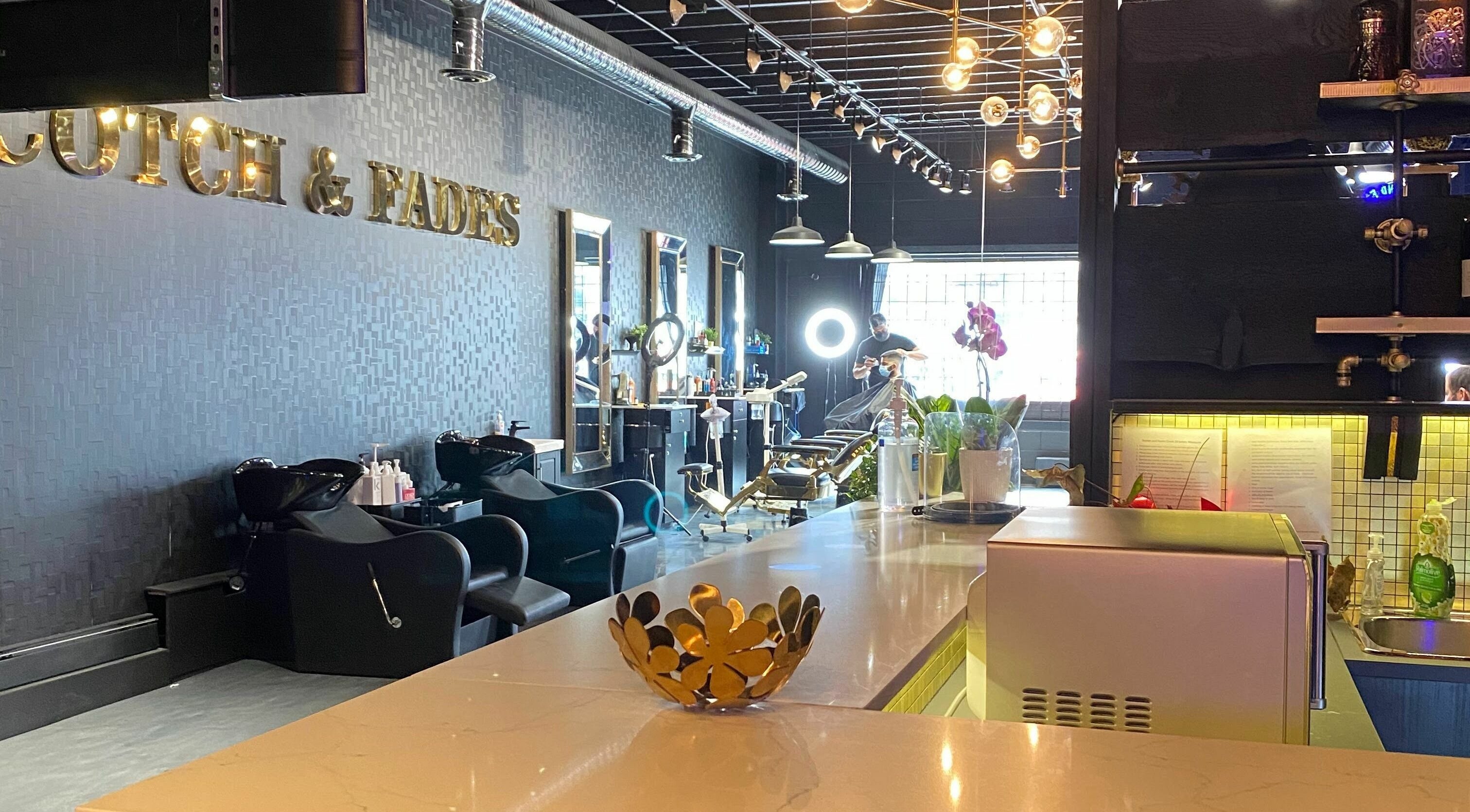Sophisticated interior of Scotch and Fades salon in Vancouver, British Columbia, CA, featuring modern styling chairs.
