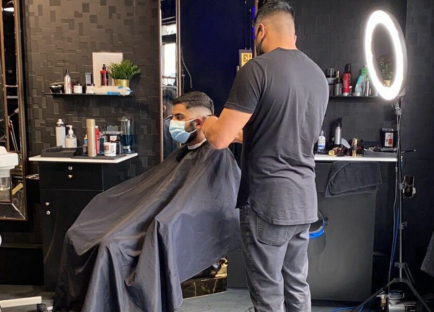 Professional barber styling a client's hair at Scotch and Fades in Vancouver, British Columbia, CA.