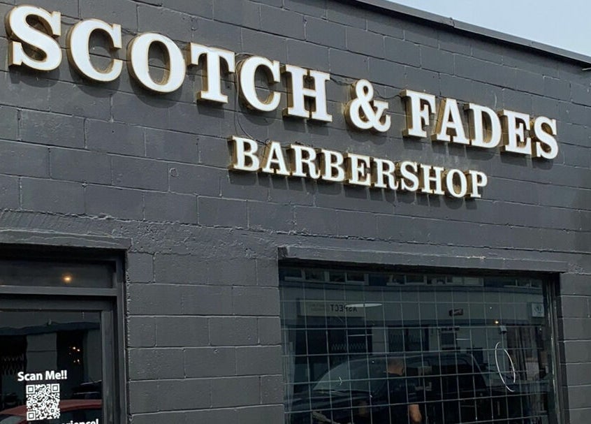 Front view of Scotch and Fades barbershop in Vancouver, British Columbia, CA with bold sign.