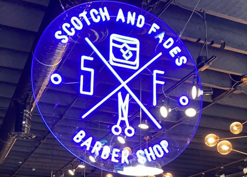 Neon sign of Scotch and Fades barbershop in Vancouver, British Columbia, CA.