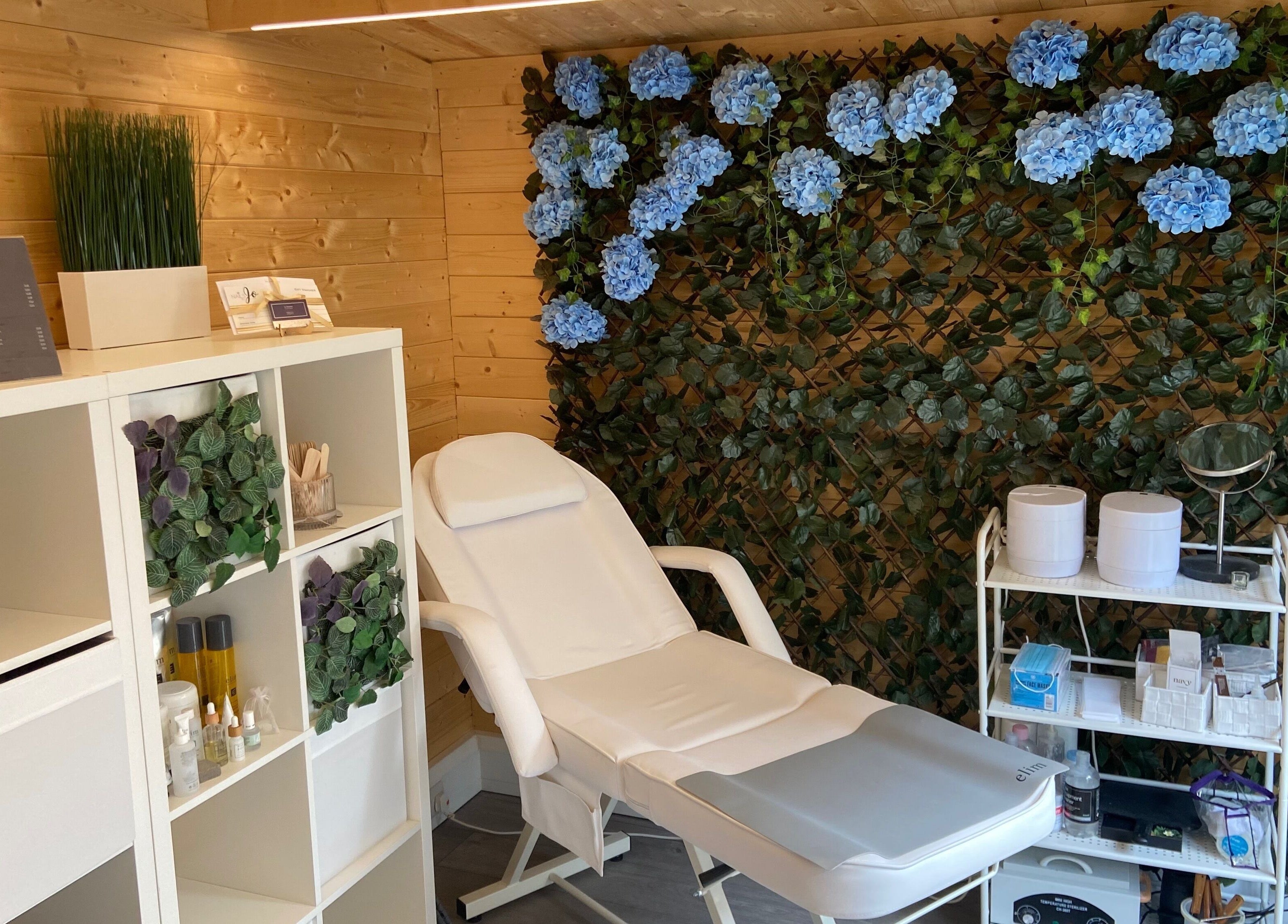 Tranquil nail salon at Nails By Jo in Fremington, England, GB, featuring a white chair and floral decor.