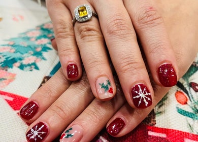 Festive nail art at Blue Moon Nails and Beauty in Hull, England, GB featuring red and white designs.