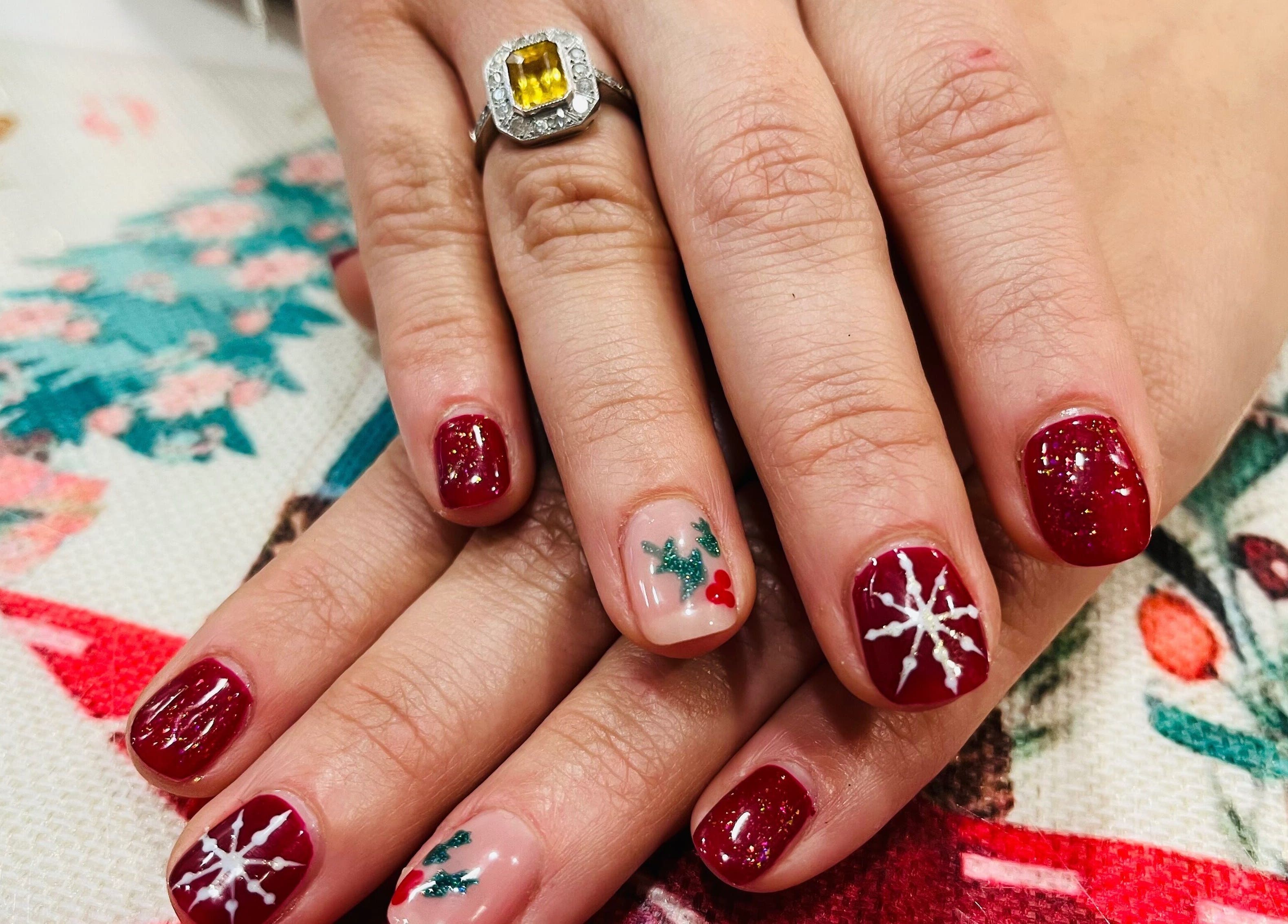 Festive nail art at Blue Moon Nails and Beauty in Hull, England, GB featuring red and white designs.