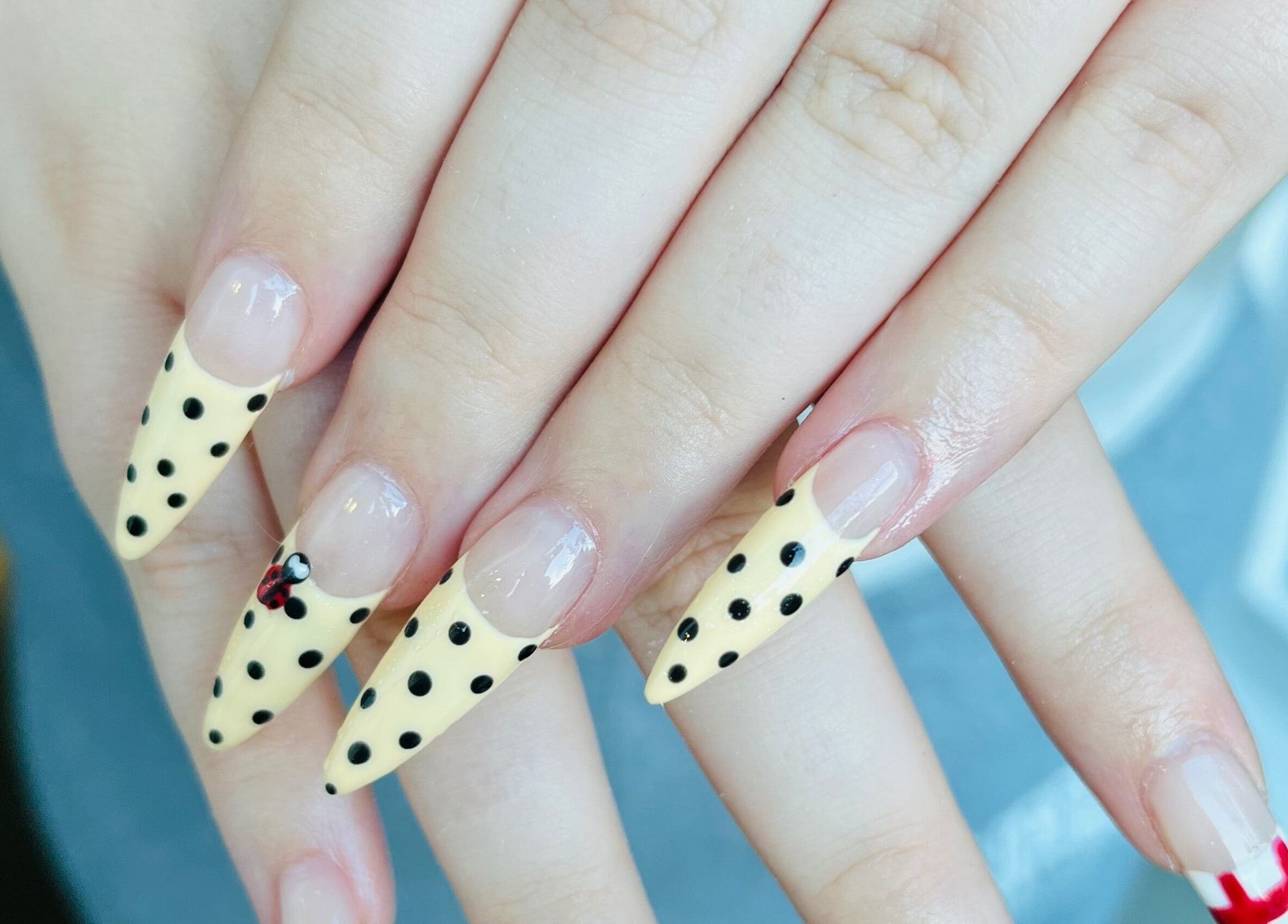 Stylish polka dot nails at Blue Moon Nails and Beauty in Hull, England, GB.