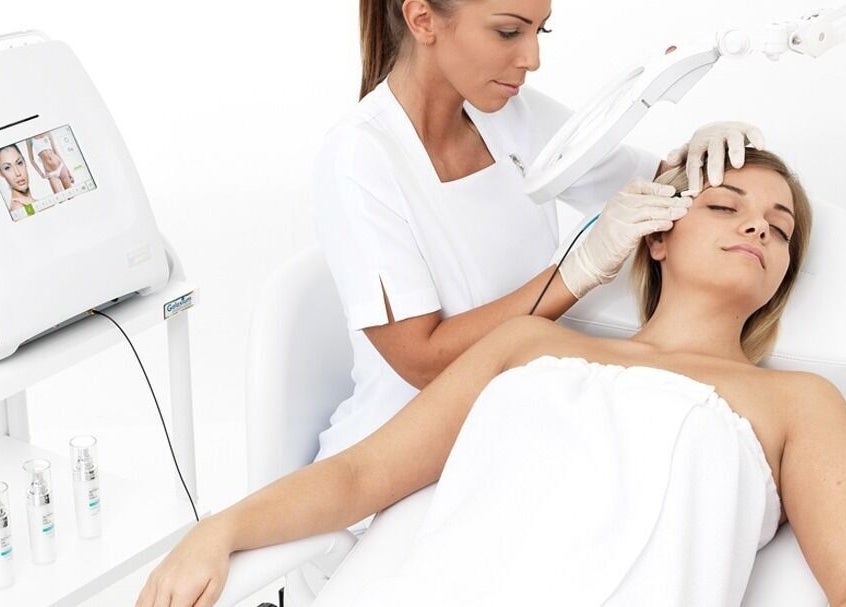 Beautician performs facial treatment at Beautiology, Auckland, Auckland, NZ, offering relaxing wellness services.