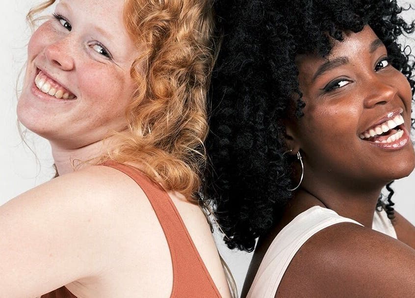 Two women with radiant smiles enjoying beauty treatments at Beautiology, Auckland, Auckland, NZ.
