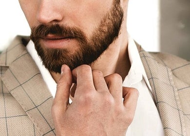 Close-up of a well-groomed man in a suit, epitomizing style at Beautiology, Auckland, NZ.
