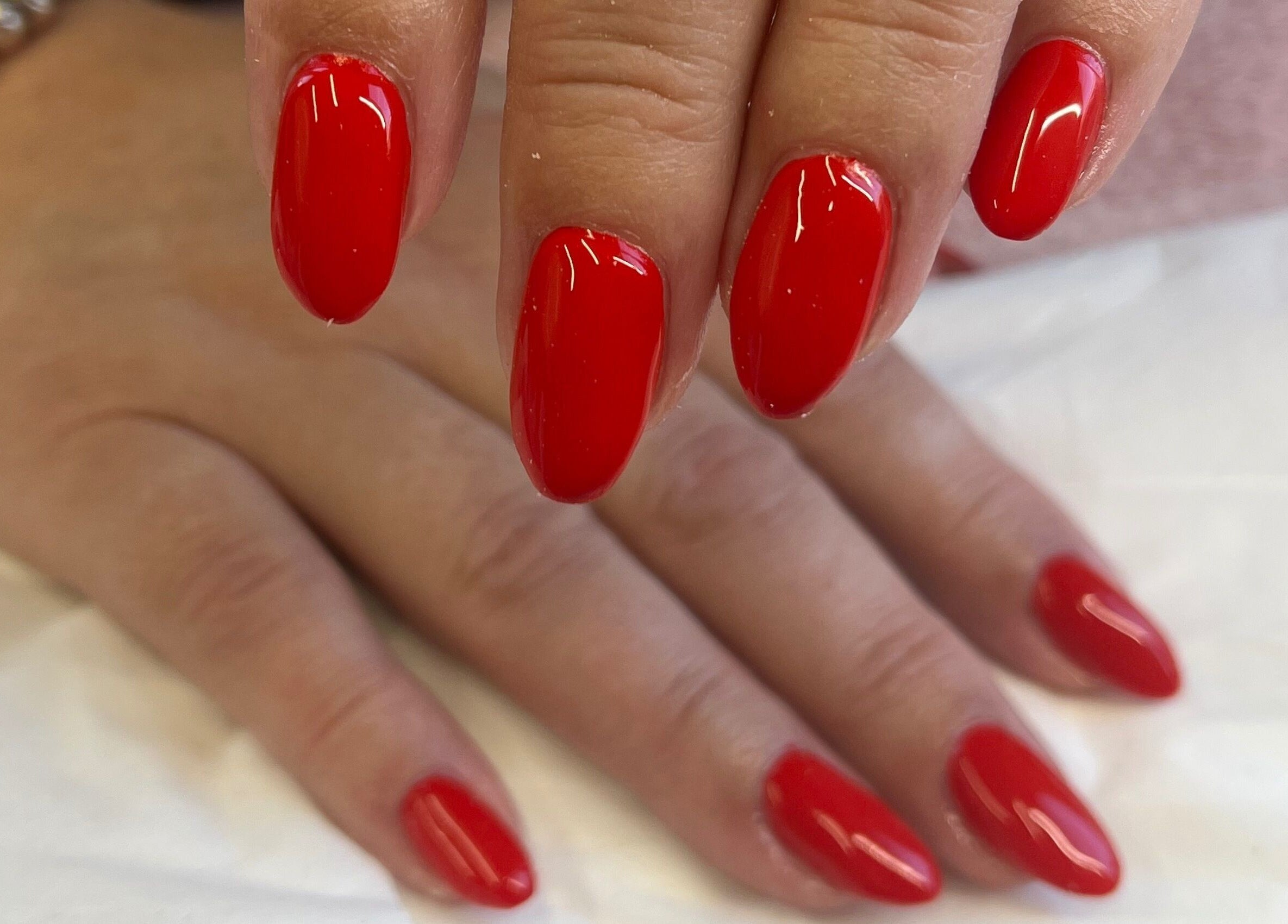 Vibrant red nail art at Magpie Nails, Havant, England, GB.